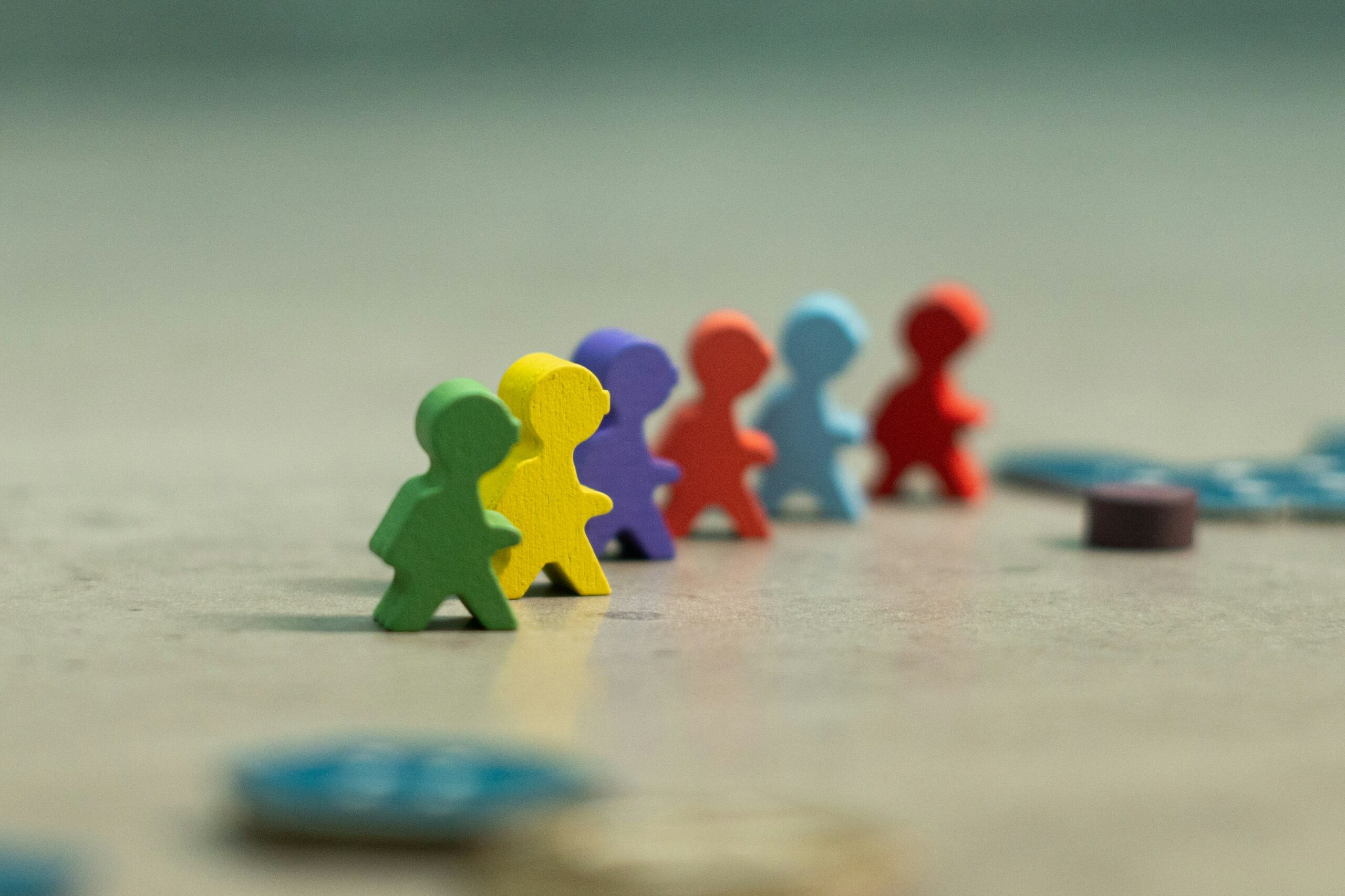 Decorative image of a group of colorful plastic figures representing diverse communities and inclusion